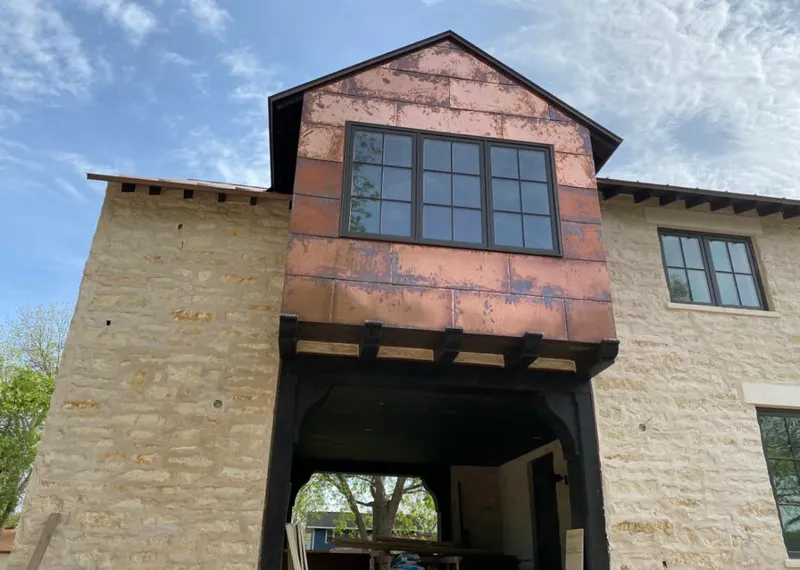 Copper metal panel facade on a stone building for Skylight Installation in Glenview