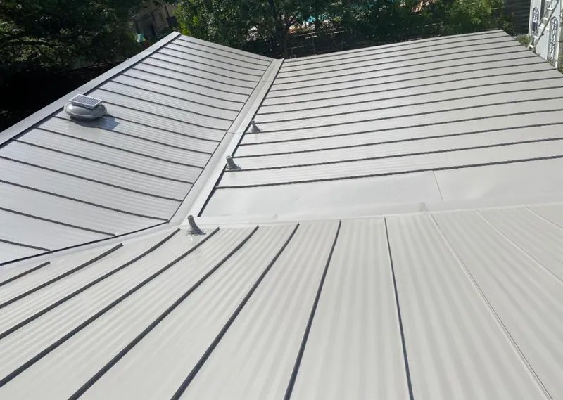 Solar attic fan installed on a metal roof for Roof Ventilation in Glenview
